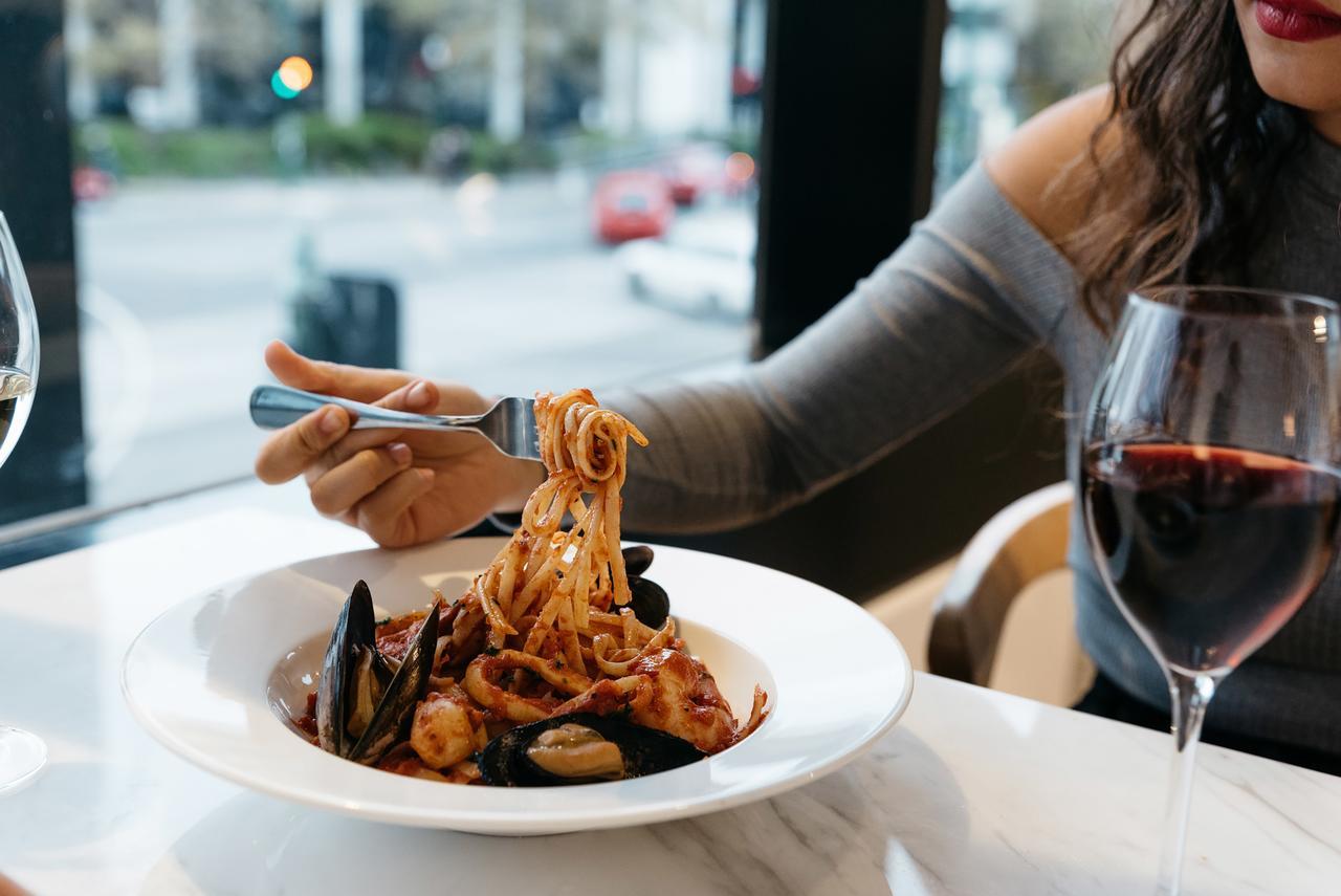 Art Series - The Chen Box Hill Eksteriør bilde A woman eating a pasta dish